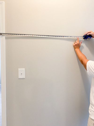 Measure wall space from edge of door until furthest point on both sides of door.